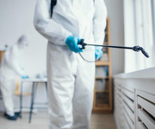people-disinfecting-biohazard-area